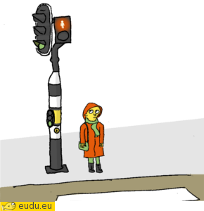 Een klein meisje bij het stoplicht.