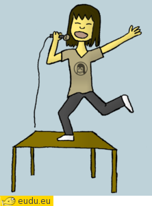 Een meisje zingt en danst op een tafel.